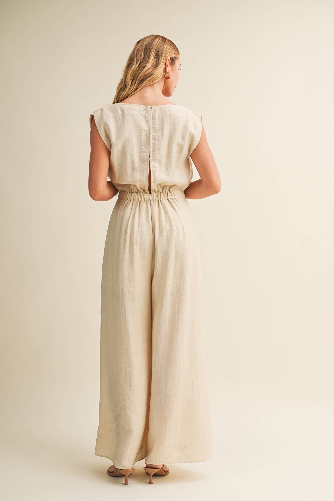 ream wide leg jumpsuit, cowl neck jumpsuit, linen blend jumpsuit, neutral one piece outfit, drawstring waist jumpsuit, resort wear jumpsuit, cap sleeve jumpsuit, flowy wide leg romper, elegant casual jumpsuit, women's cream jumpsuit