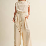 ream wide leg jumpsuit, cowl neck jumpsuit, linen blend jumpsuit, neutral one piece outfit, drawstring waist jumpsuit, resort wear jumpsuit, cap sleeve jumpsuit, flowy wide leg romper, elegant casual jumpsuit, women's cream jumpsuit