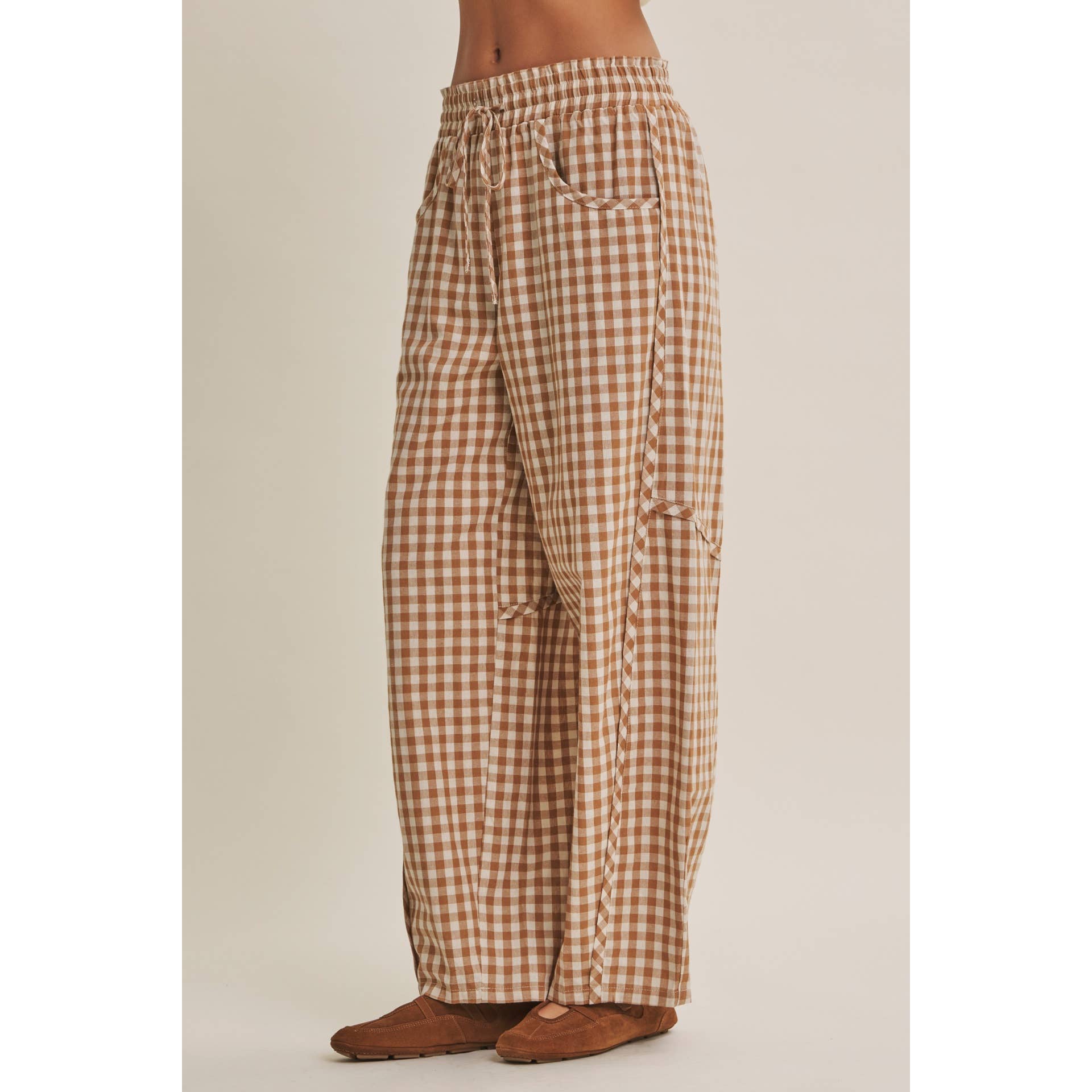 relaxed brown and cream gingham barrel pants in 100% cotton with an elastic drawstring waist, curved seaming and oversized pockets.