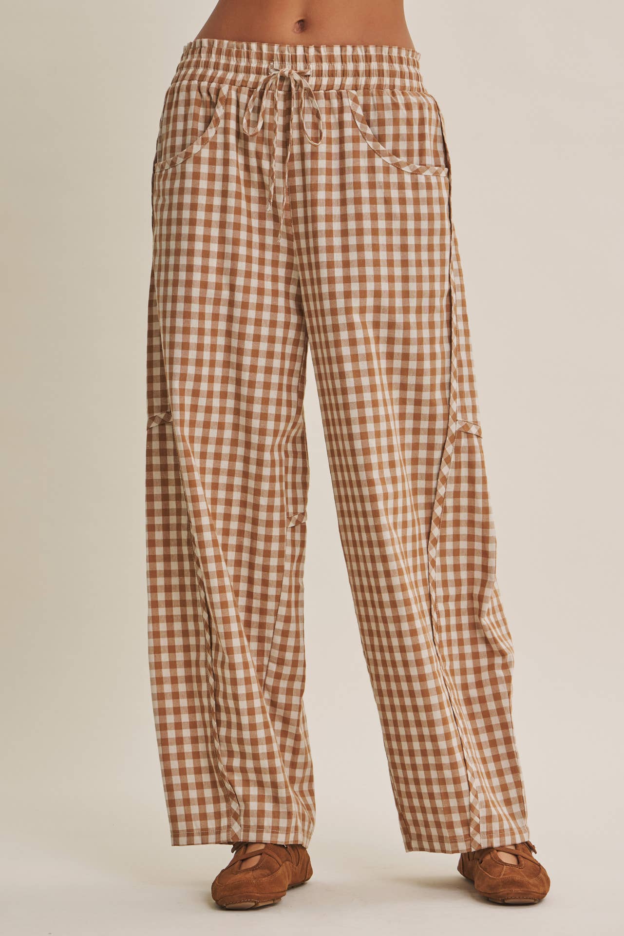 relaxed brown and cream gingham barrel pants in 100% cotton with an elastic drawstring waist, curved seaming and oversized pockets.