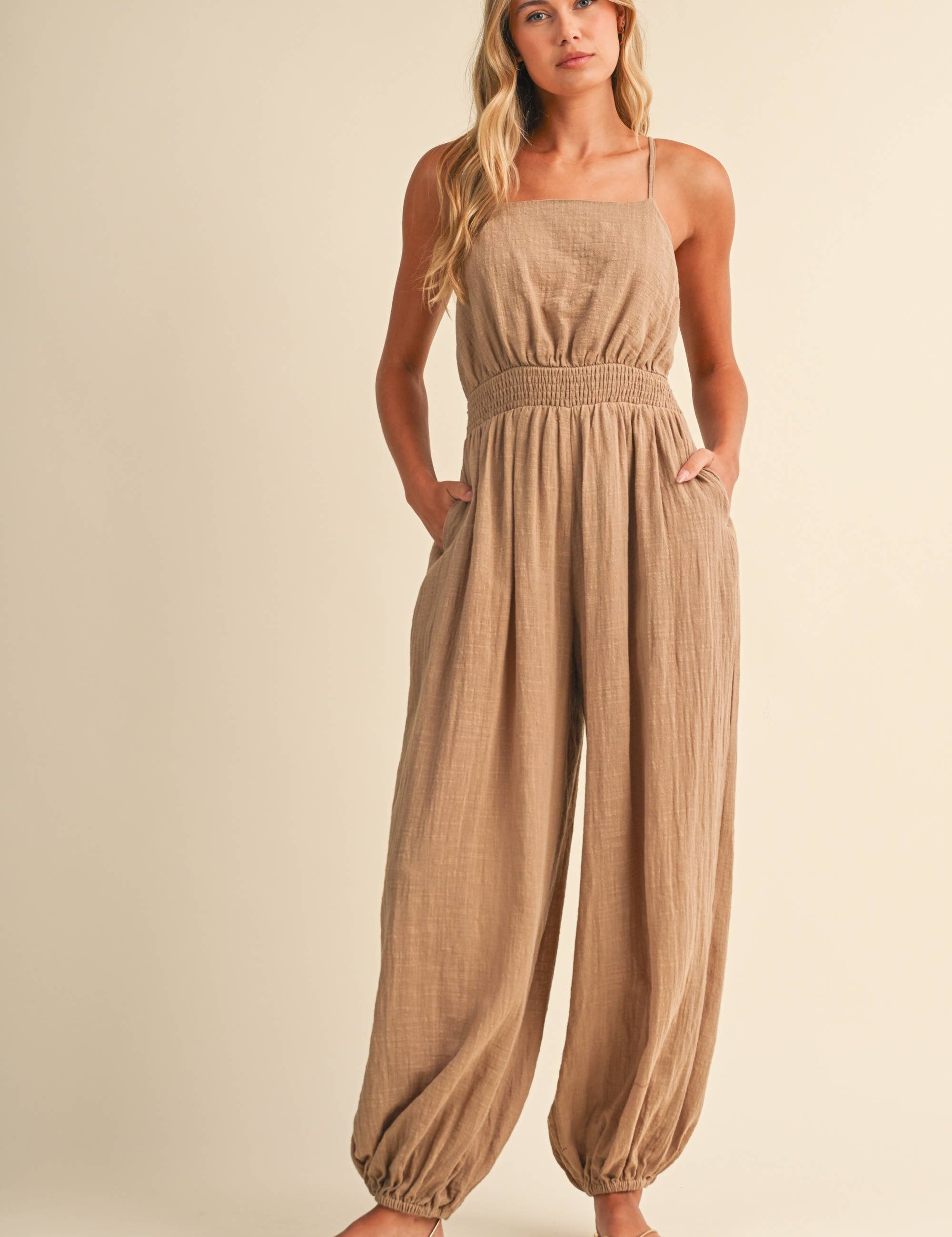 linen blend jumpsuit, tan jumpsuit women, bow back jumpsuit, smocked waist jumpsuit, square neck jumpsuit, relaxed fit one piece outfit, boho jumpsuit, wide leg jumpsuit, neutral summer jumpsuit, lightweight vacation outfit