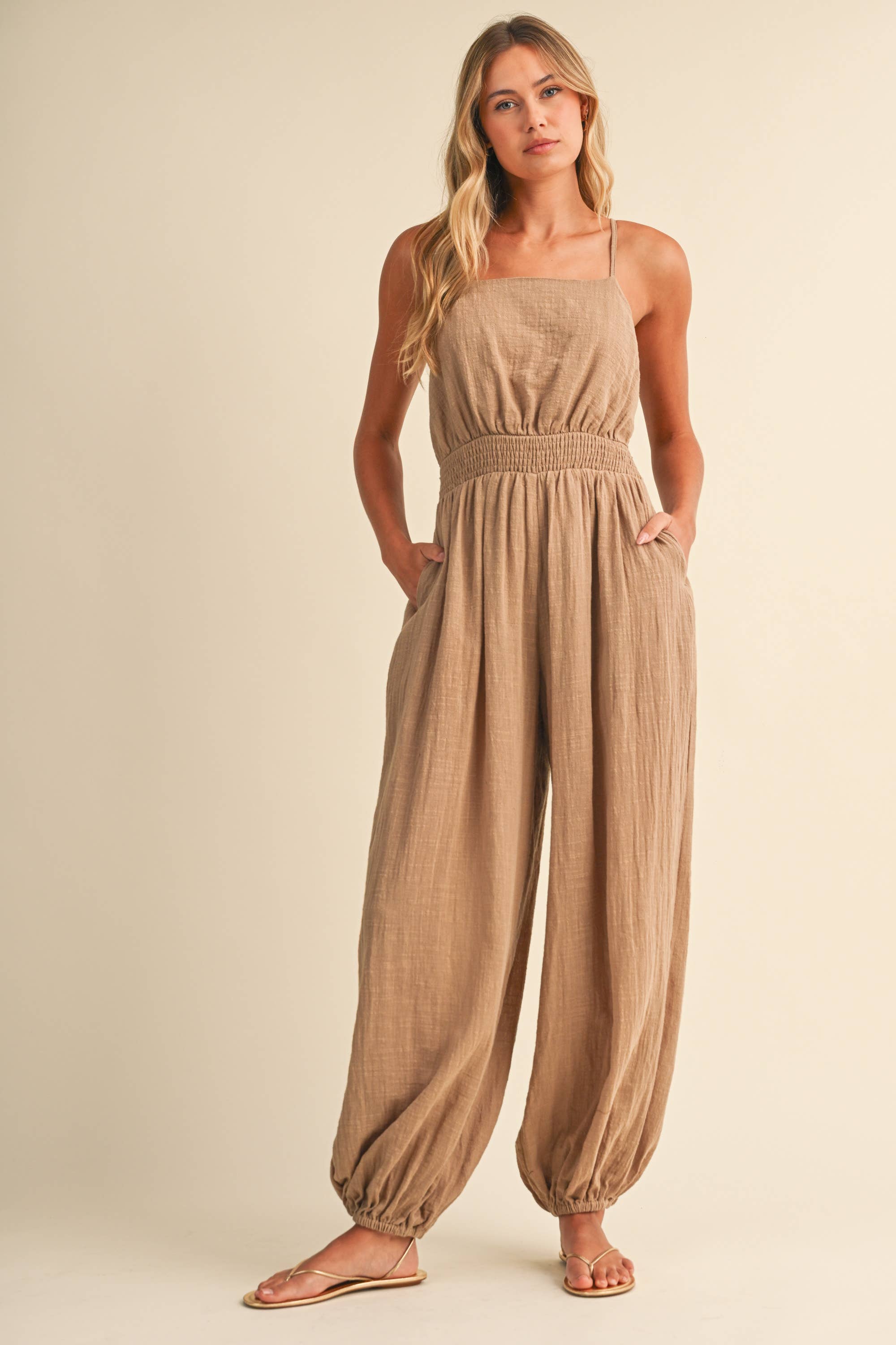 linen blend jumpsuit, tan jumpsuit women, bow back jumpsuit, smocked waist jumpsuit, square neck jumpsuit, relaxed fit one piece outfit, boho jumpsuit, wide leg jumpsuit, neutral summer jumpsuit, lightweight vacation outfit