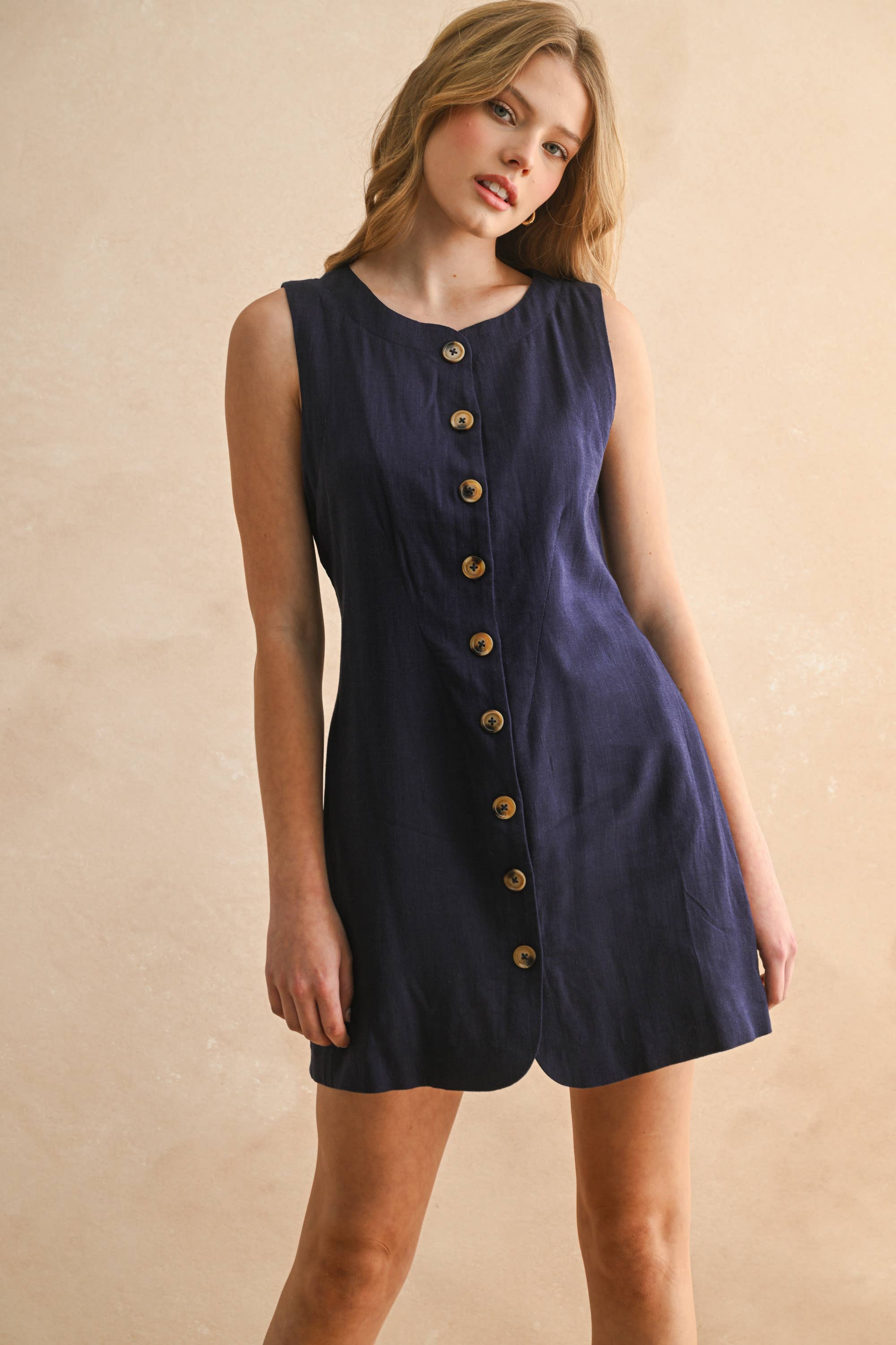 navy linen dress
button front linen dress
sleeveless mini dress
navy summer dress
linen shift dress
navy casual dress
linen dress with pockets
button front mini dress
fully lined linen dress
adjustable back tie dress
classic summer dress
navy sleeveless dress
boutique linen clothing
vacation dress women
timeless summer style
casual linen dress
women's linen mini dress
easy summer outfit
linen dress with buttons
americana summer fashion
