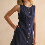 navy linen dress
button front linen dress
sleeveless mini dress
navy summer dress
linen shift dress
navy casual dress
linen dress with pockets
button front mini dress
fully lined linen dress
adjustable back tie dress
classic summer dress
navy sleeveless dress
boutique linen clothing
vacation dress women
timeless summer style
casual linen dress
women's linen mini dress
easy summer outfit
linen dress with buttons
americana summer fashion