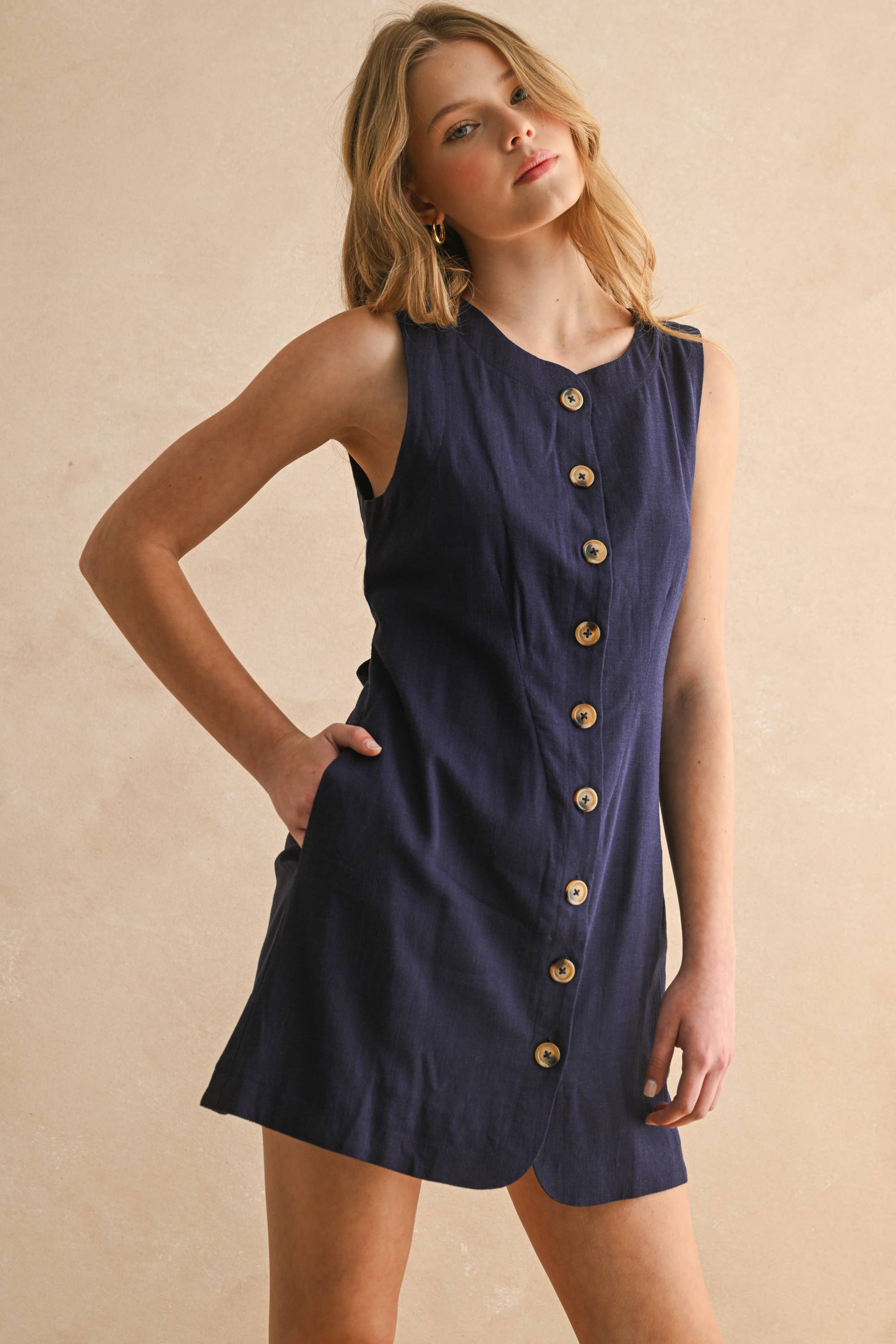 navy linen dress
button front linen dress
sleeveless mini dress
navy summer dress
linen shift dress
navy casual dress
linen dress with pockets
button front mini dress
fully lined linen dress
adjustable back tie dress
classic summer dress
navy sleeveless dress
boutique linen clothing
vacation dress women
timeless summer style
casual linen dress
women's linen mini dress
easy summer outfit
linen dress with buttons
americana summer fashion