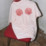 seashell graphic t-shirt
pink shell graphic tee
relaxed fit cotton graphic tee
coastal graphic t-shirt women
outer banks inspired tee
summer casual graphic shirt
light pink cotton t-shirt women
beach inspired graphic tee
casual summer outfit graphic tee
women’s relaxed fit shell shirt
summer spritz collection graphic tee