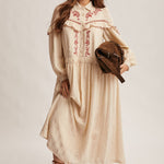 cream embroidered maxi dress with rust floral detailing, ruffled yoke, long puff sleeves and button front