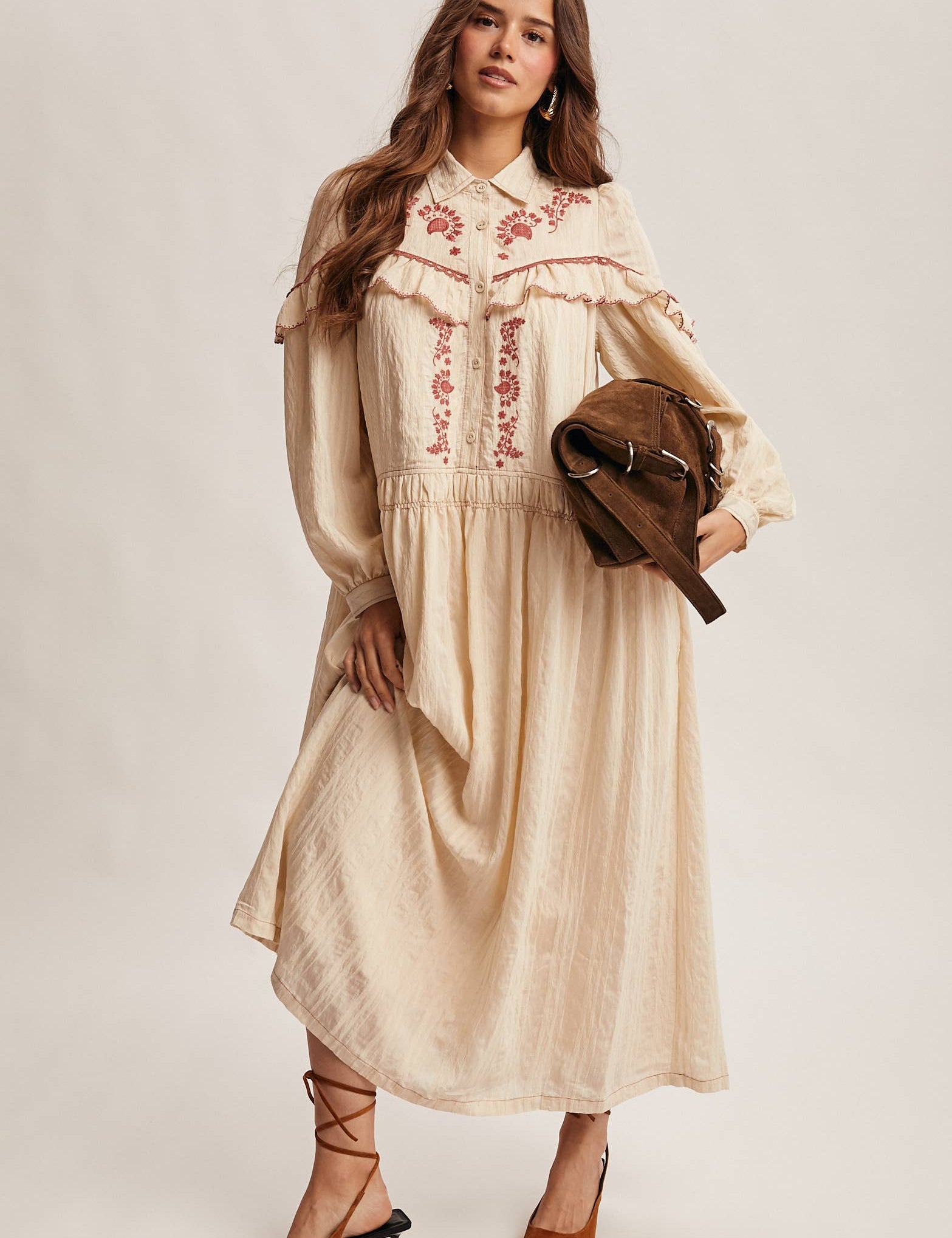 cream embroidered maxi dress with rust floral detailing, ruffled yoke, long puff sleeves and button front