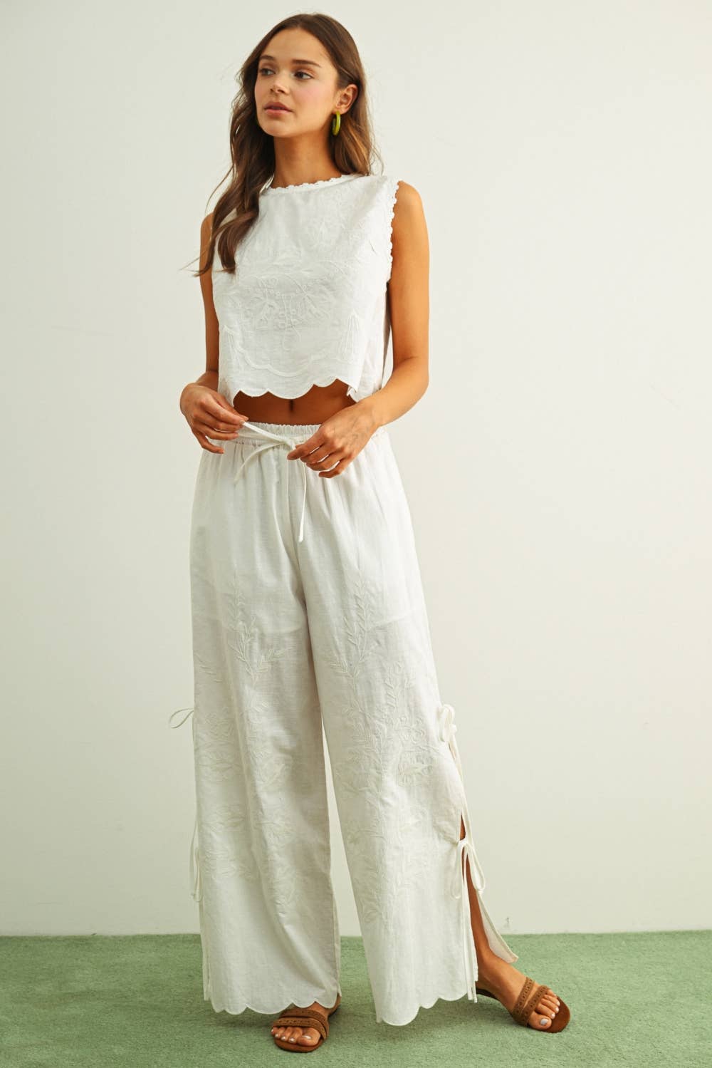embroidered cotton linen sleeveless top with side ties
white embroidered tank top with relaxed boxy fit
cotton linen sleeveless blouse with tie side detail
lightweight embroidered summer top in white
relaxed fit cotton linen tank with embroidery
white sleeveless top paired with matching linen pants
breathable cotton linen blouse for summer
embroidered neutral top with hip length silhouette
bridal outfit
honeymoon outfit