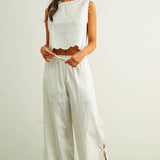 embroidered cotton linen sleeveless top with side ties
white embroidered tank top with relaxed boxy fit
cotton linen sleeveless blouse with tie side detail
lightweight embroidered summer top in white
relaxed fit cotton linen tank with embroidery
white sleeveless top paired with matching linen pants
breathable cotton linen blouse for summer
embroidered neutral top with hip length silhouette
bridal outfit
honeymoon outfit