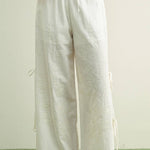 white embroidered cotton linen wide leg pants
relaxed fit embroidered pants with side tie details
lightweight cotton linen pants with wide leg silhouette
white summer pants with embroidery accents
breathable cotton linen trousers for women
matching set embroidered wide leg pants
neutral resort wear pants with side tie detail
elevated white linen blend pants for summer
honeymoon outfit
bachelorette outfit
bridal outfit
