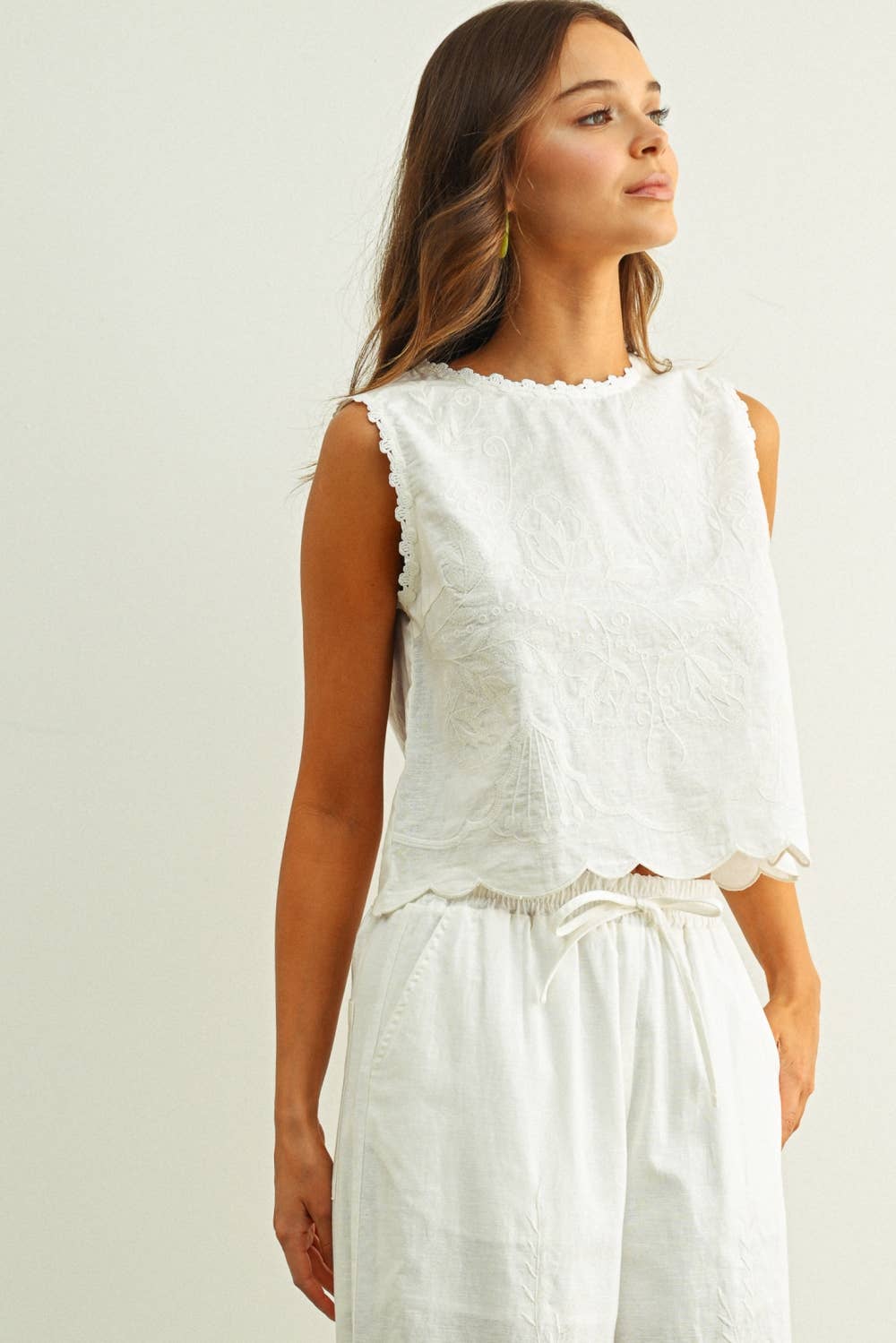 embroidered cotton linen sleeveless top with side ties
white embroidered tank top with relaxed boxy fit
cotton linen sleeveless blouse with tie side detail
lightweight embroidered summer top in white
relaxed fit cotton linen tank with embroidery
white sleeveless top paired with matching linen pants
breathable cotton linen blouse for summer
embroidered neutral top with hip length silhouette
bridal outfit
bachelorette outfit
honeymoon outfit