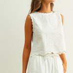 embroidered cotton linen sleeveless top with side ties
white embroidered tank top with relaxed boxy fit
cotton linen sleeveless blouse with tie side detail
lightweight embroidered summer top in white
relaxed fit cotton linen tank with embroidery
white sleeveless top paired with matching linen pants
breathable cotton linen blouse for summer
embroidered neutral top with hip length silhouette
bridal outfit
bachelorette outfit
honeymoon outfit
