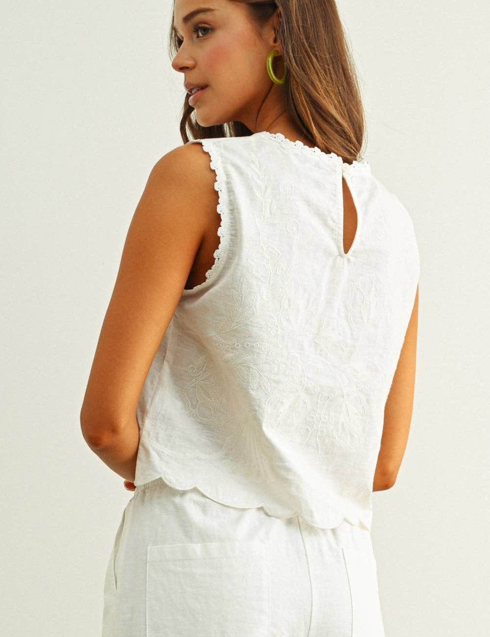 embroidered cotton linen sleeveless top with side ties
white embroidered tank top with relaxed boxy fit
cotton linen sleeveless blouse with tie side detail
lightweight embroidered summer top in white
relaxed fit cotton linen tank with embroidery
white sleeveless top paired with matching linen pants
breathable cotton linen blouse for summer
embroidered neutral top with hip length silhouette
bridal outfit
bachelorette outfit
bridal shower outfit