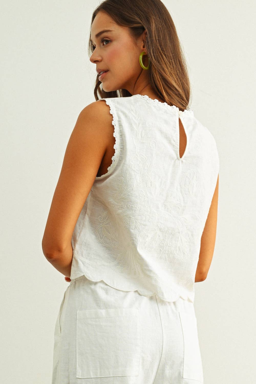 embroidered cotton linen sleeveless top with side ties
white embroidered tank top with relaxed boxy fit
cotton linen sleeveless blouse with tie side detail
lightweight embroidered summer top in white
relaxed fit cotton linen tank with embroidery
white sleeveless top paired with matching linen pants
breathable cotton linen blouse for summer
embroidered neutral top with hip length silhouette
bridal outfit
bachelorette outfit
bridal shower outfit