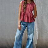 rust red sleeveless rayon blend tank top with front pleats, crew neckline and relaxed gathered silhouette