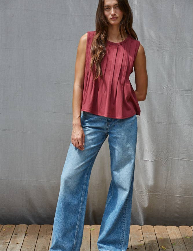 rust red sleeveless rayon blend tank top with front pleats, crew neckline and relaxed gathered silhouette