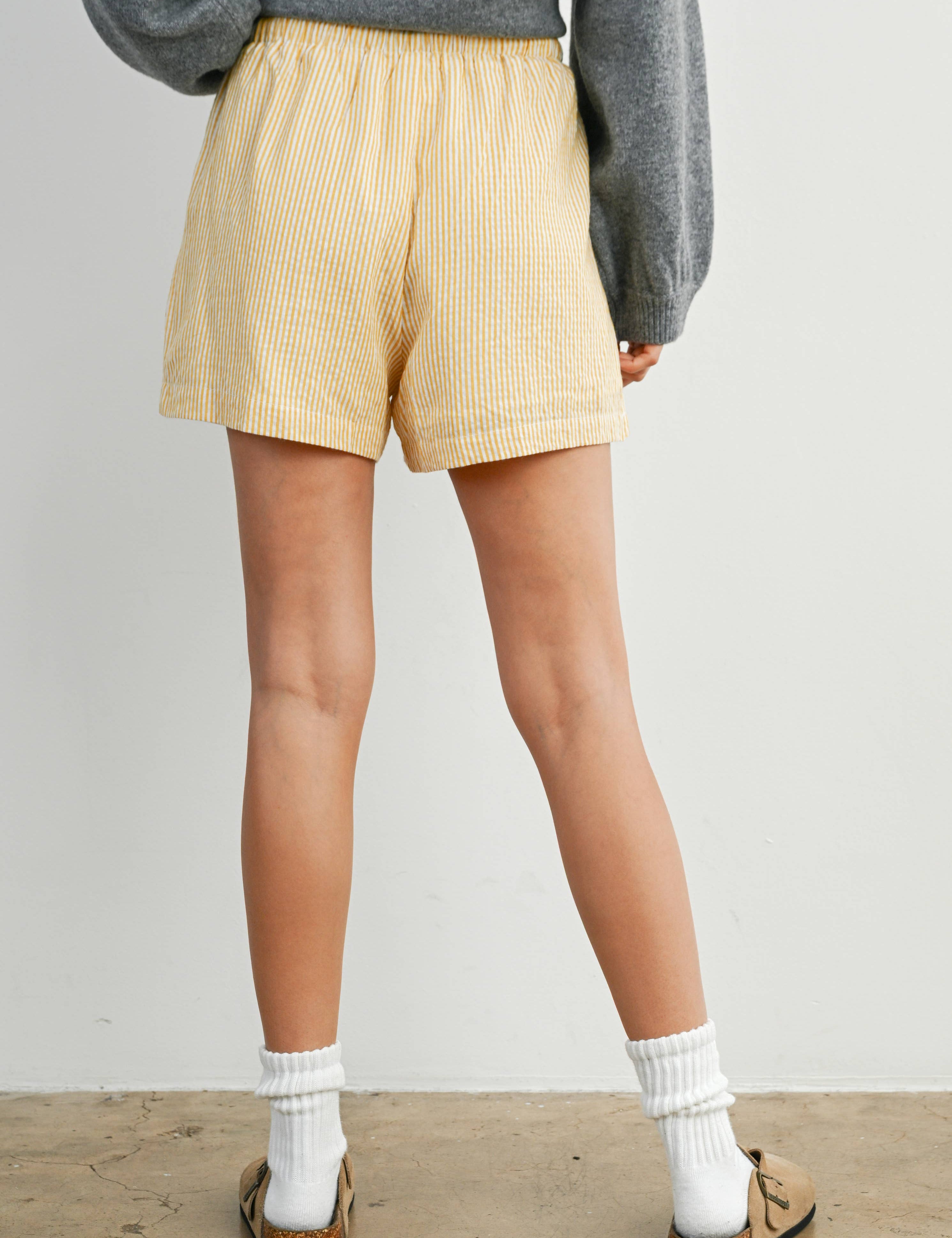 yellow striped drawstring shorts
coastal summer shorts women
lightweight vacation shorts
relaxed striped lounge shorts
elastic waist casual shorts women
resort wear boutique shorts
beach vacation outfit women
casual coastal style shorts
summer drawstring shorts women
west of may spritz collection