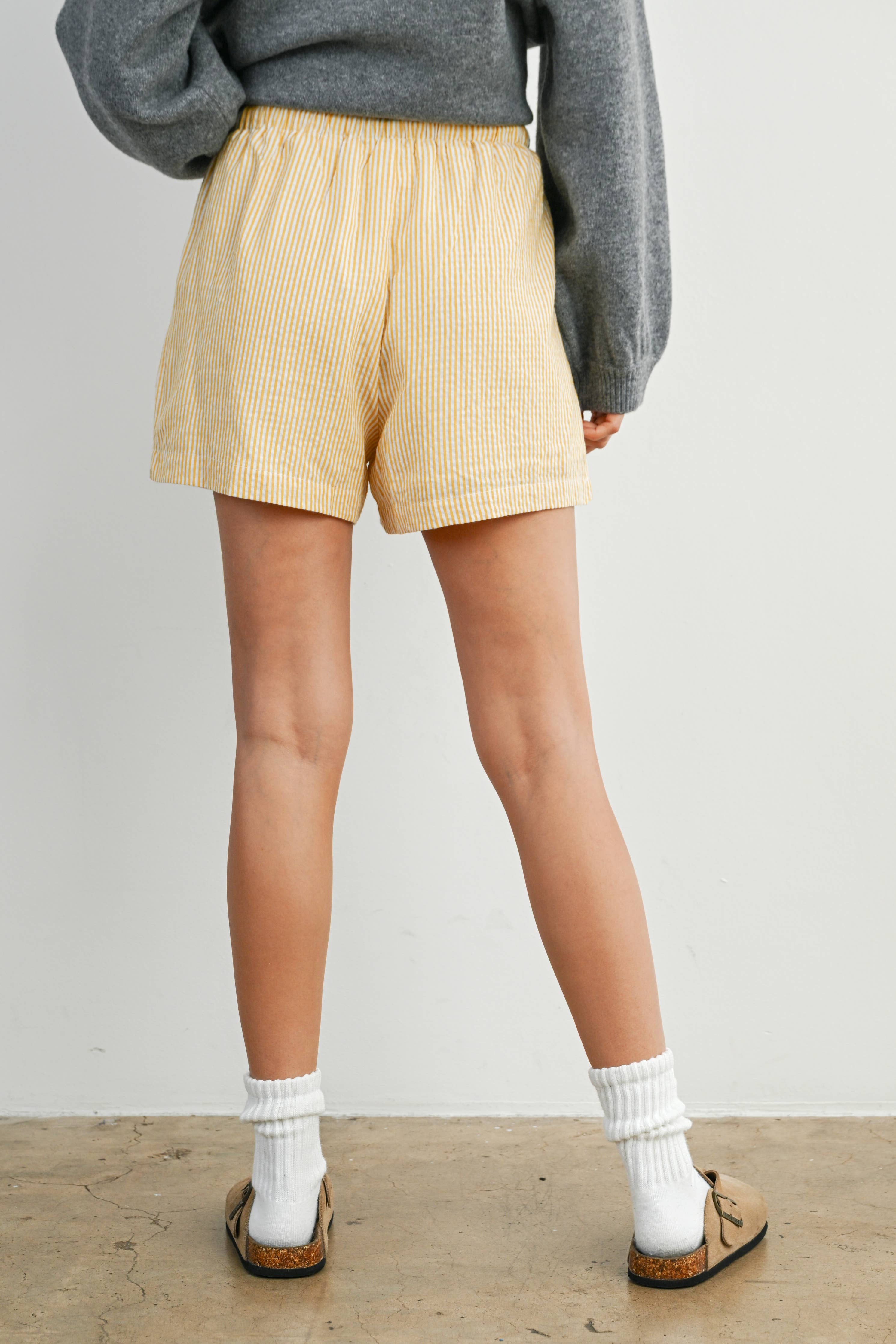 yellow striped drawstring shorts
coastal summer shorts women
lightweight vacation shorts
relaxed striped lounge shorts
elastic waist casual shorts women
resort wear boutique shorts
beach vacation outfit women
casual coastal style shorts
summer drawstring shorts women
west of may spritz collection