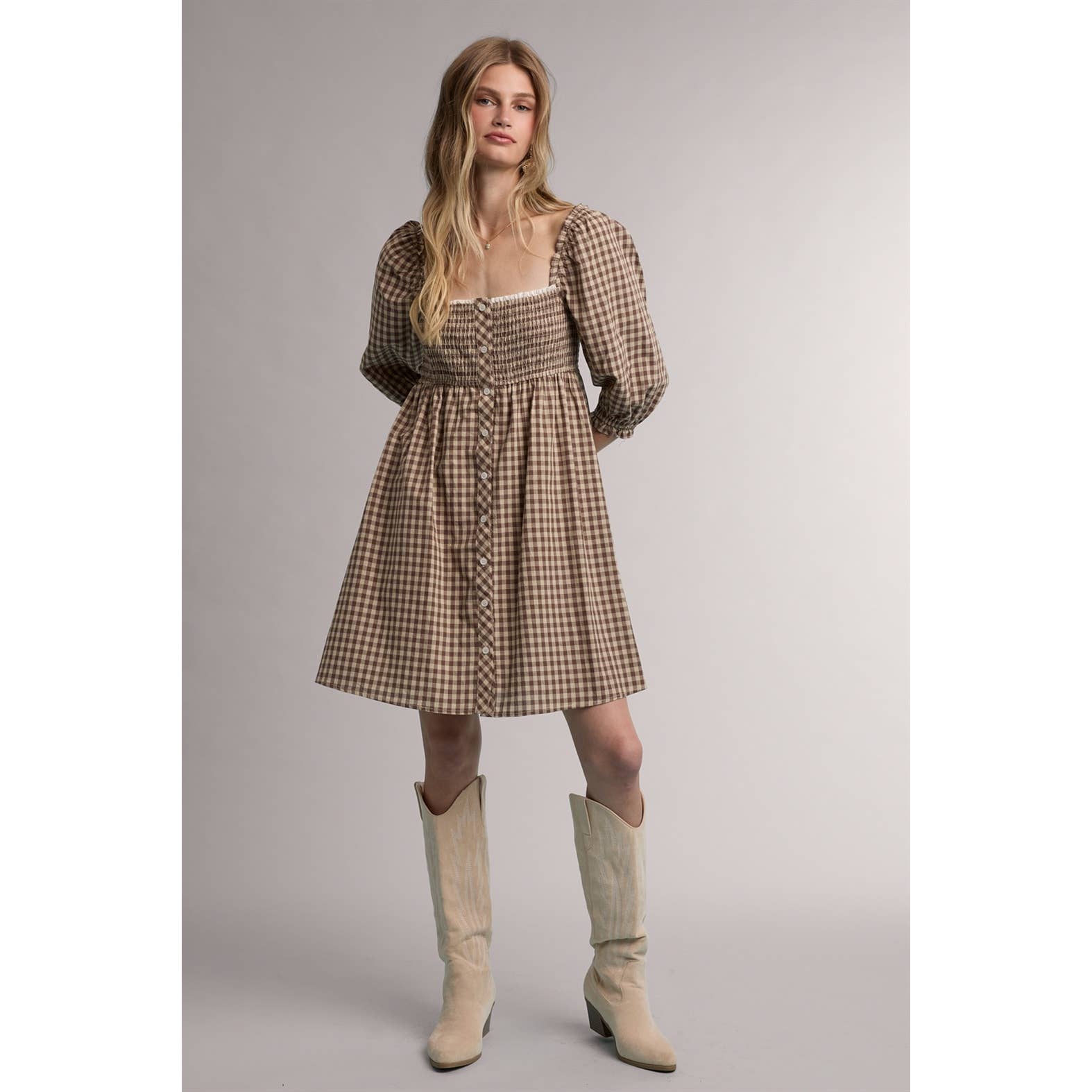 women's brown gingham dress, brown gingham mini dress, gingham babydoll dress, women's fall mini dress, square neck mini dress, smocked bodice dress, puff sleeve gingham dress, brown plaid dress, western fall dress, cowgirl mini dress, fall dress with boots, women's casual fall dress, cotton gingham dress, women's boutique fall clothing, western women's clothing, fall boutique dress, west of may