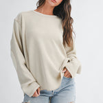 women's cream waffle knit thermal top with mixed fabric panels, long sleeves, drop shoulders, and oversized relaxed fit
