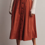 rust corduroy midi skirt, orange corduroy skirt, women’s button front skirt, a-line midi skirt, high waisted corduroy skirt, fall midi skirt, pleated midi skirt, women’s fall skirt, corduroy skirt with pockets, thanksgiving outfit skirt, western midi skirt, boutique fall skirt