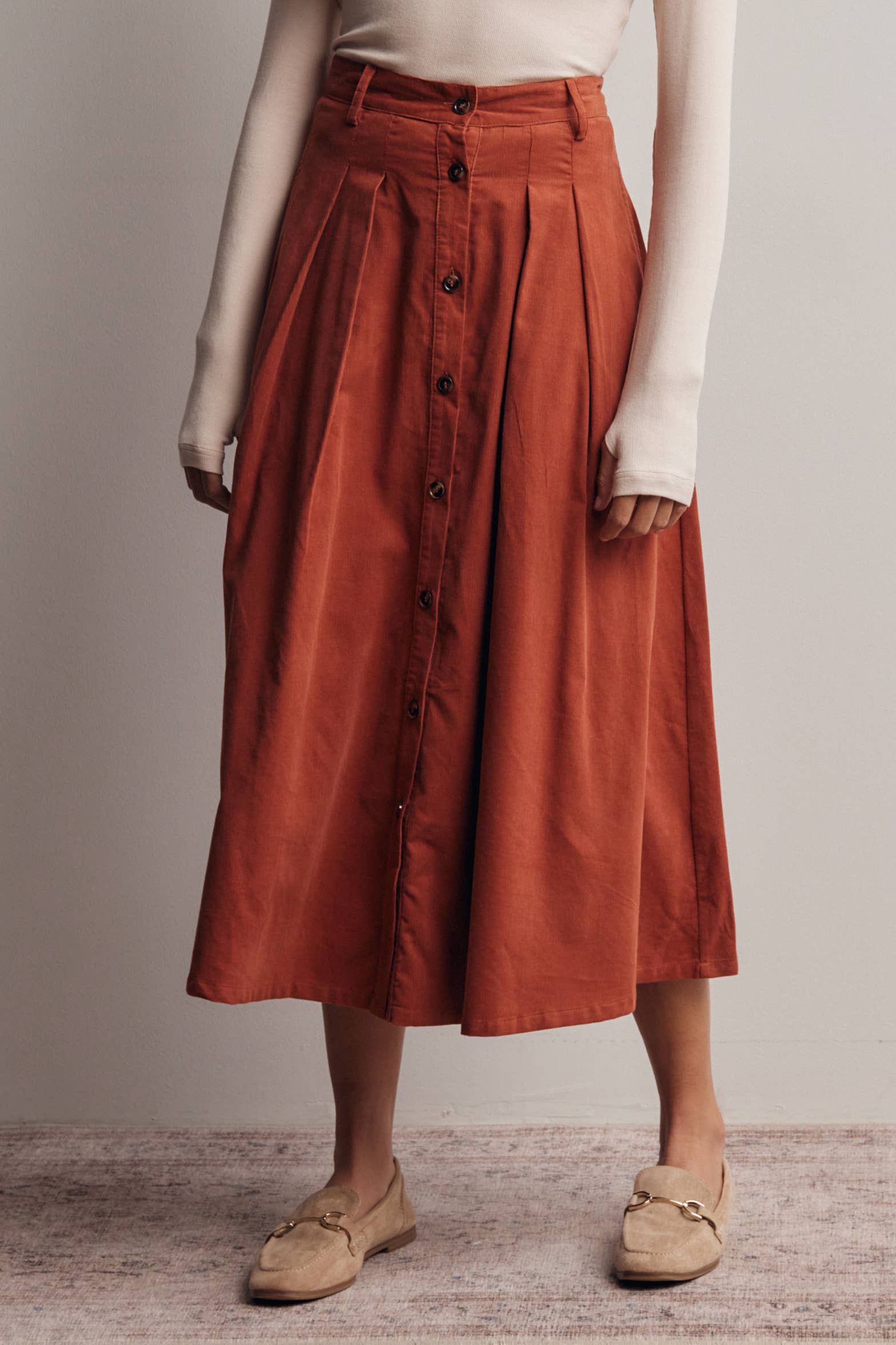 rust corduroy midi skirt, orange corduroy skirt, women’s button front skirt, a-line midi skirt, high waisted corduroy skirt, fall midi skirt, pleated midi skirt, women’s fall skirt, corduroy skirt with pockets, thanksgiving outfit skirt, western midi skirt, boutique fall skirt