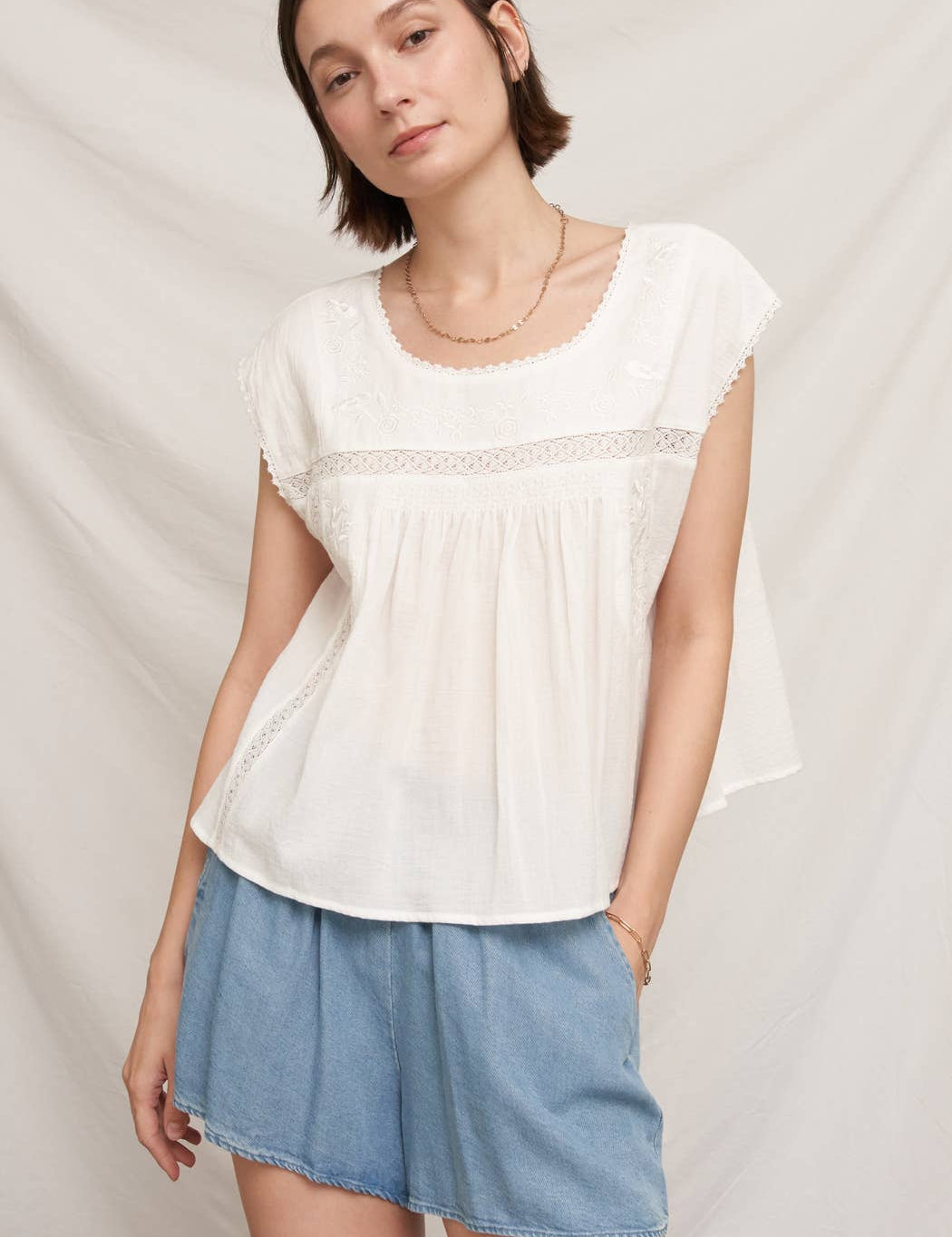 white embroidered blouse
embroidered summer top
white peasant blouse
lightweight rayon blouse
feminine summer top
casual white boutique top
embroidered detail shirt
relaxed fit white blouse
summer farmers market outfit
southern summer style
easy vacation outfit
white top with embroidery
flowy summer blouse
countryside summer fashion
casual feminine clothing
breathable warm weather top
white short sleeve blouse
classic summer wardrobe staple
boutique women's clothing
effortless everyday style