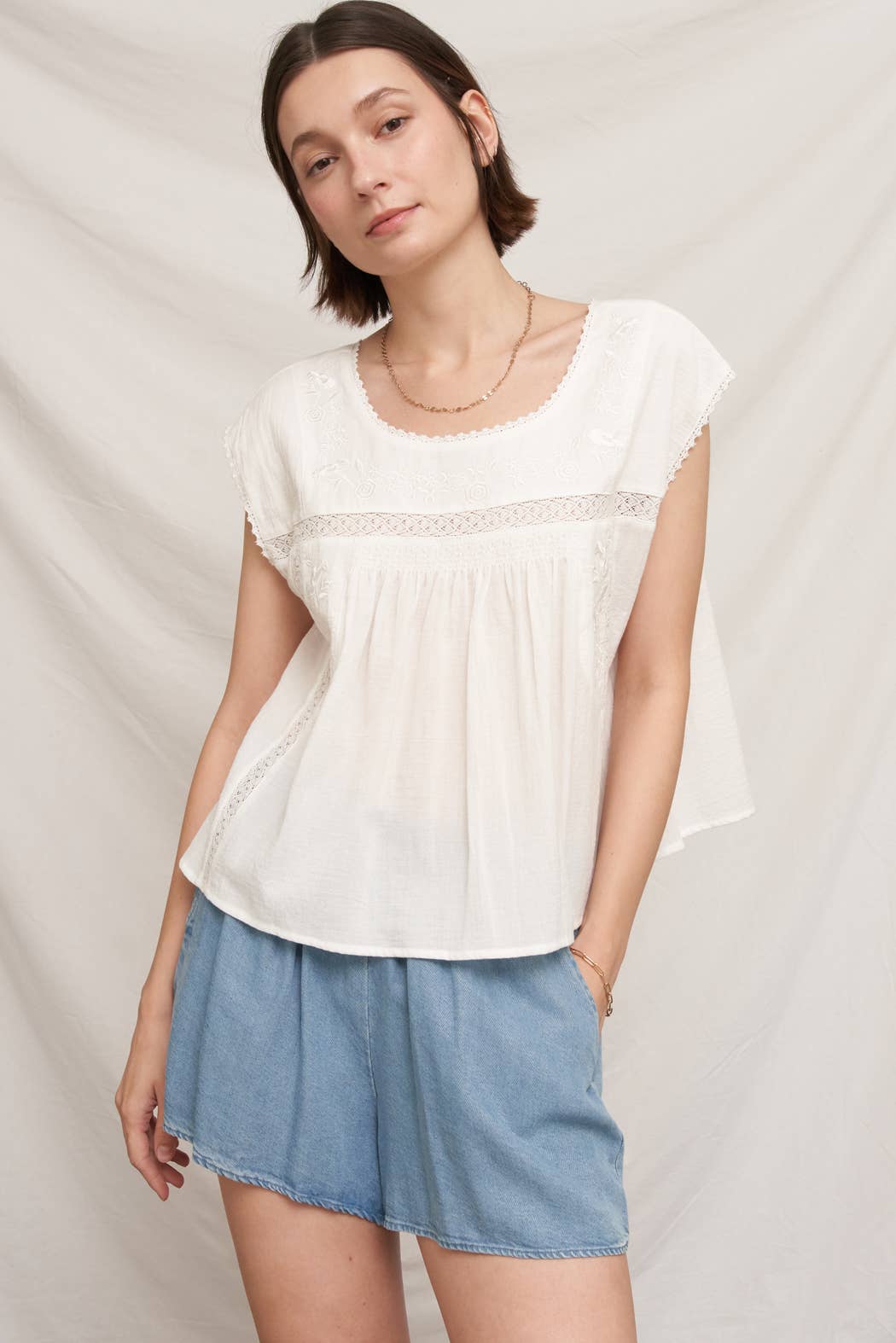 white embroidered blouse
embroidered summer top
white peasant blouse
lightweight rayon blouse
feminine summer top
casual white boutique top
embroidered detail shirt
relaxed fit white blouse
summer farmers market outfit
southern summer style
easy vacation outfit
white top with embroidery
flowy summer blouse
countryside summer fashion
casual feminine clothing
breathable warm weather top
white short sleeve blouse
classic summer wardrobe staple
boutique women's clothing
effortless everyday style