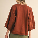 oversized button-up sweatshirt, cotton button-up sweatshirt, oversized cotton top, rust sweatshirt, exposed seam sweatshirt, relaxed fit sweatshirt, lightweight sweatshirt jacket, fall layering top, casual women's sweatshirt, boutique fall top, west of may boutique, free people dupe, boho style