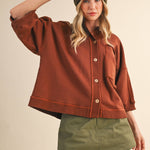 oversized button-up sweatshirt, cotton button-up sweatshirt, oversized cotton top, rust sweatshirt, exposed seam sweatshirt, relaxed fit sweatshirt, lightweight sweatshirt jacket, fall layering top, casual women's sweatshirt, boutique fall top, west of may boutique, free people dupe, boho style