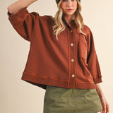 oversized button-up sweatshirt, cotton button-up sweatshirt, oversized cotton top, rust sweatshirt, exposed seam sweatshirt, relaxed fit sweatshirt, lightweight sweatshirt jacket, fall layering top, casual women's sweatshirt, boutique fall top, west of may boutique, free people dupe, boho style