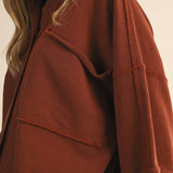 oversized button-up sweatshirt, cotton button-up sweatshirt, oversized cotton top, rust sweatshirt, exposed seam sweatshirt, relaxed fit sweatshirt, lightweight sweatshirt jacket, fall layering top, casual women's sweatshirt, boutique fall top, west of may boutique, free people dupe, boho style