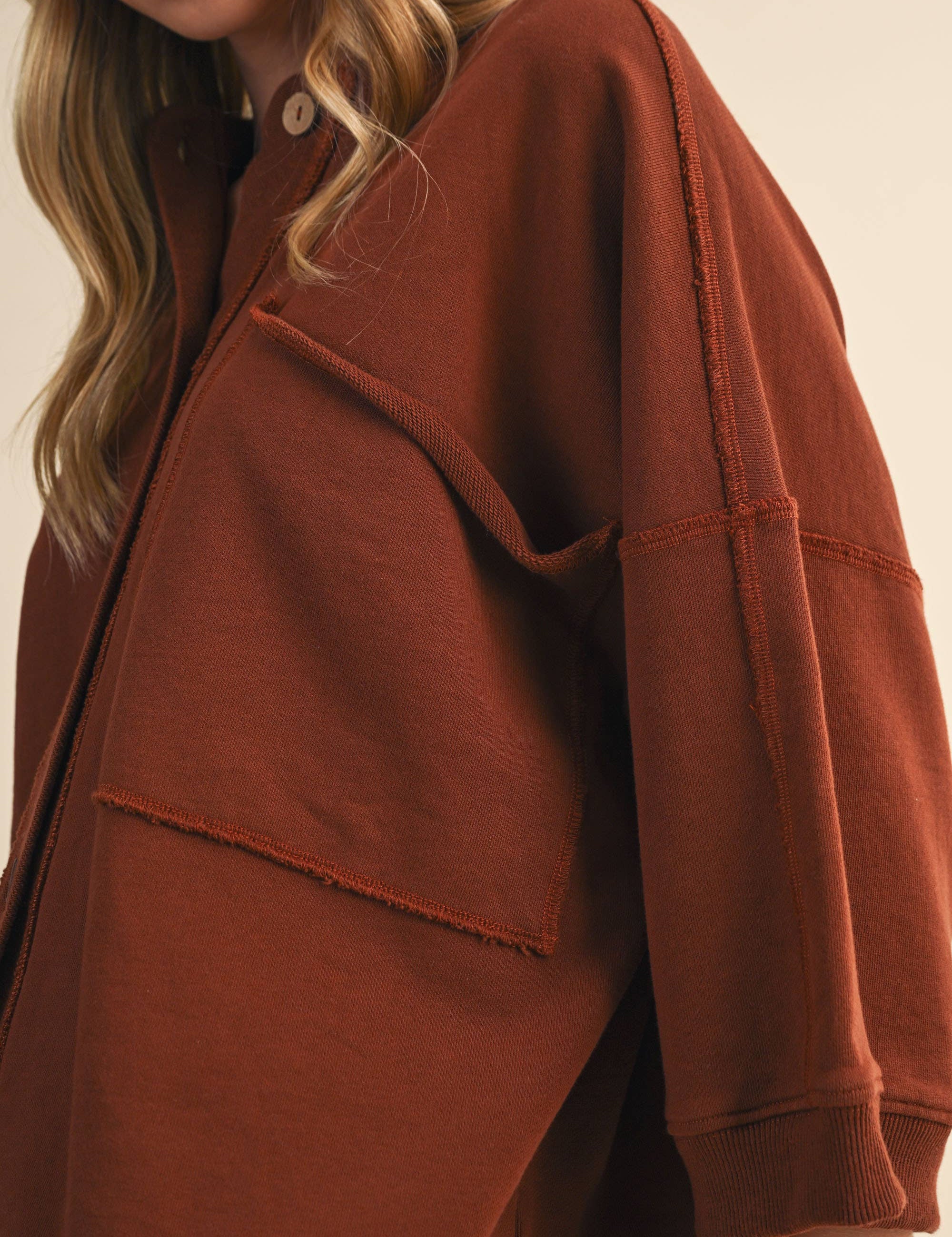 oversized button-up sweatshirt, cotton button-up sweatshirt, oversized cotton top, rust sweatshirt, exposed seam sweatshirt, relaxed fit sweatshirt, lightweight sweatshirt jacket, fall layering top, casual women's sweatshirt, boutique fall top, west of may boutique, free people dupe, boho style