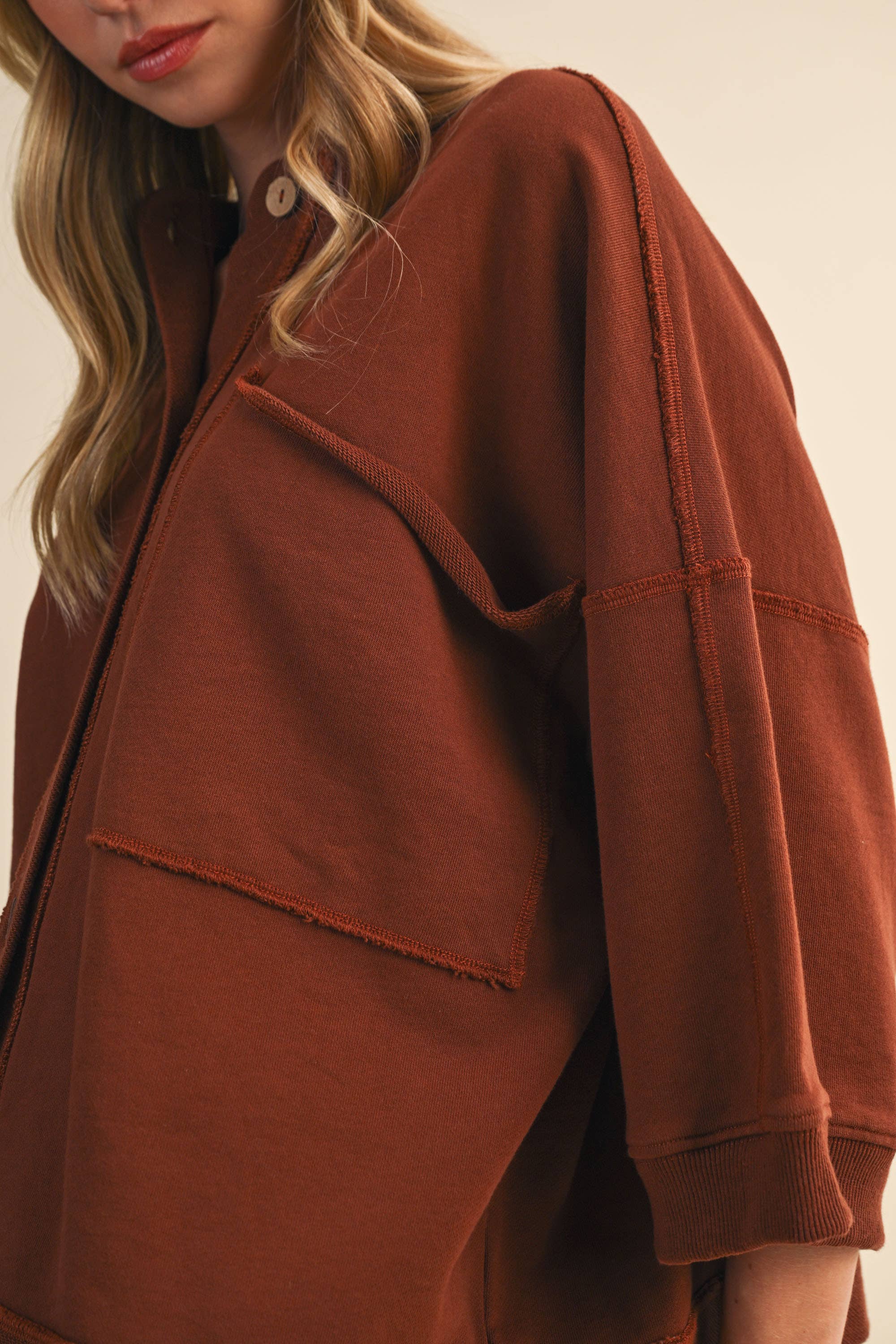 oversized button-up sweatshirt, cotton button-up sweatshirt, oversized cotton top, rust sweatshirt, exposed seam sweatshirt, relaxed fit sweatshirt, lightweight sweatshirt jacket, fall layering top, casual women's sweatshirt, boutique fall top, west of may boutique, free people dupe, boho style