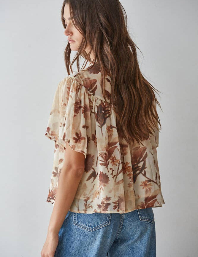 women's cream floral blouse, cream and brown floral top, brown floral blouse women, floral mock neck blouse, fall floral blouse, women's chiffon floral top, short sleeve floral blouse, flutter sleeve floral top, vintage floral blouse, western floral blouse, prairie floral top, boho western blouse, women's fall blouse, neutral floral top, cream fall top women, brown floral fall top, floral top with jeans, western fall outfit women, cowgirl fall outfit, women's western clothing, women's boutique tops